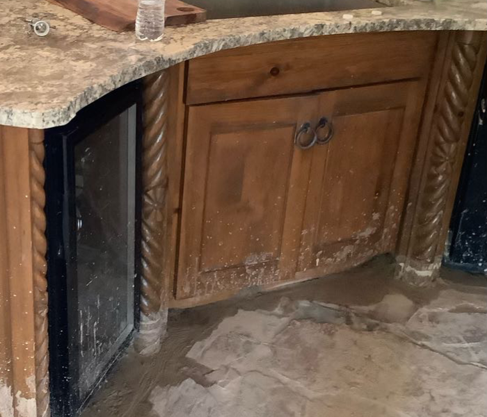 Mud that affected kitchen cabinets and flooring 