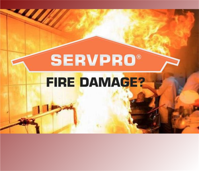Fire inside a commercial kitchen with SERVPRO logo centered