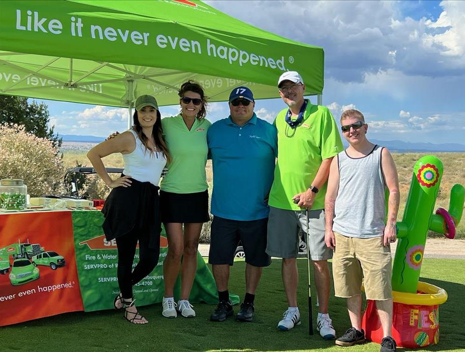 Our team standing in front of a SERVPRO tent for a charity event